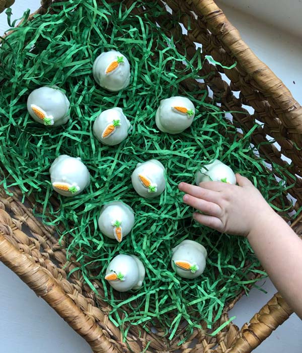 Hand grabbing Carrot Cake Balls in Easter Basket