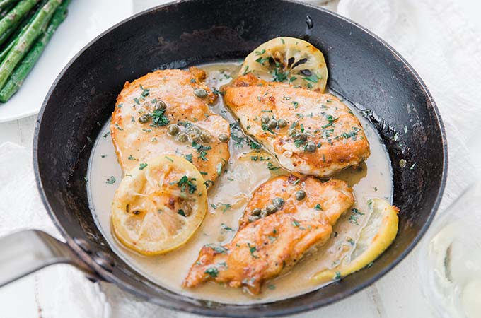 Chicken Piccata in Pan with Sauce and Lemon Slices