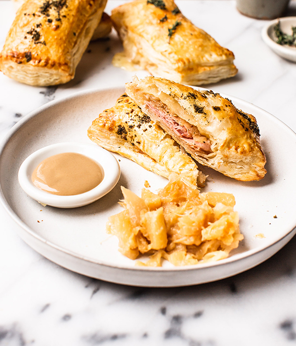 Ham and Cheese Turnovers on Plate with Sauce