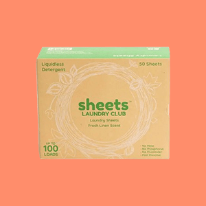 A Box of Sheets Laundry Club Detergent Sheets on a Peach Colored Background