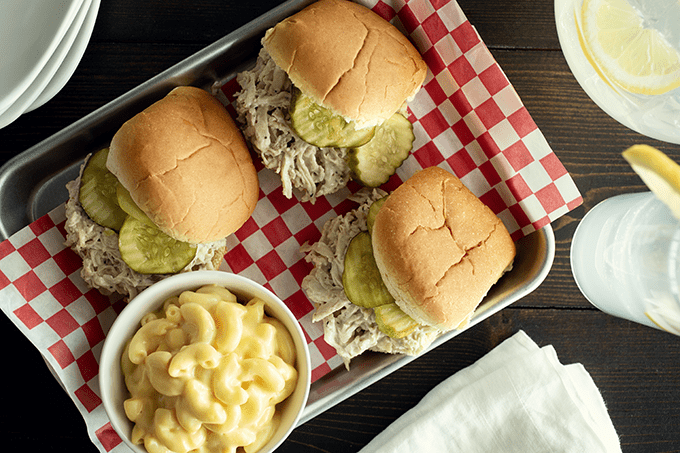 3 Alabama White BBQ Chicken Sliders served on a tray with mac and cheese