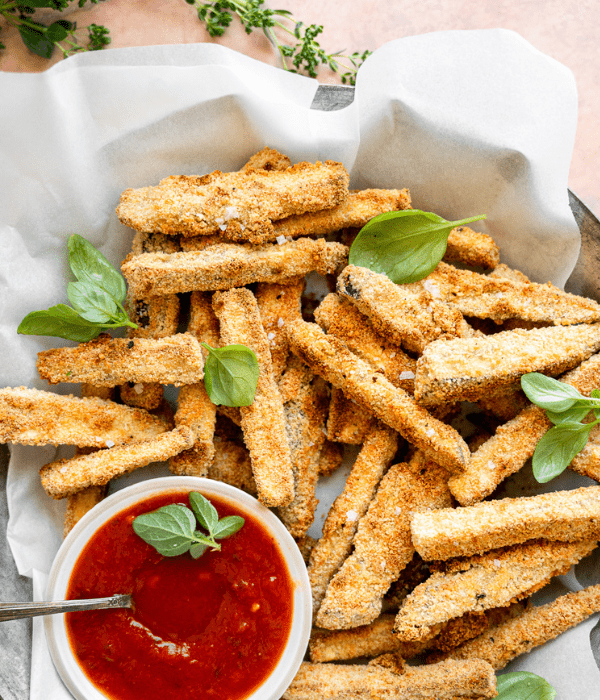 Bowl of crispy eggplant Fries with a side bowl of Heinen’s Marinara for dipping.