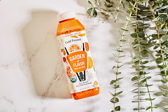 Garden of Flavor Cold-Pressed Turmeric Crush Juice on a Marble Backdrop