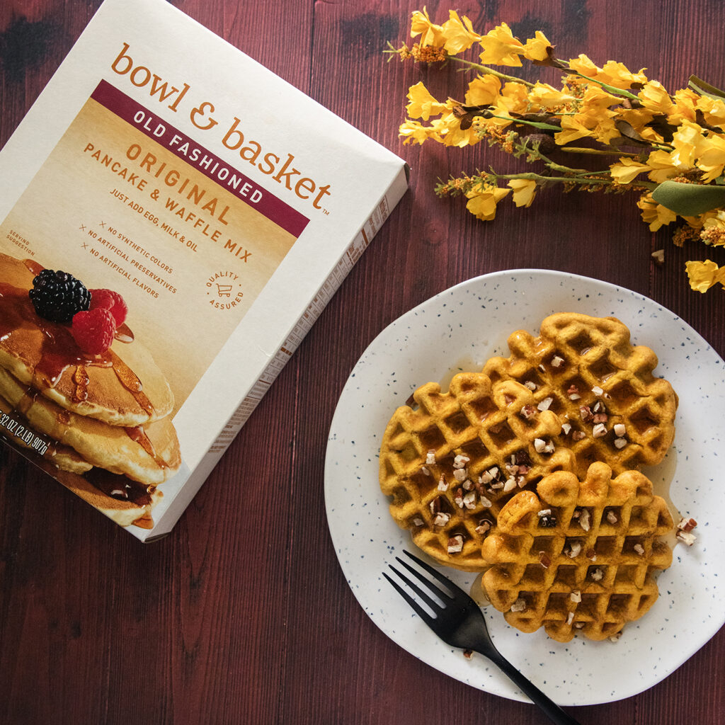 A Box of Bowl and Basket Pancake and Waffle Mix Beside a Plate of Waffles