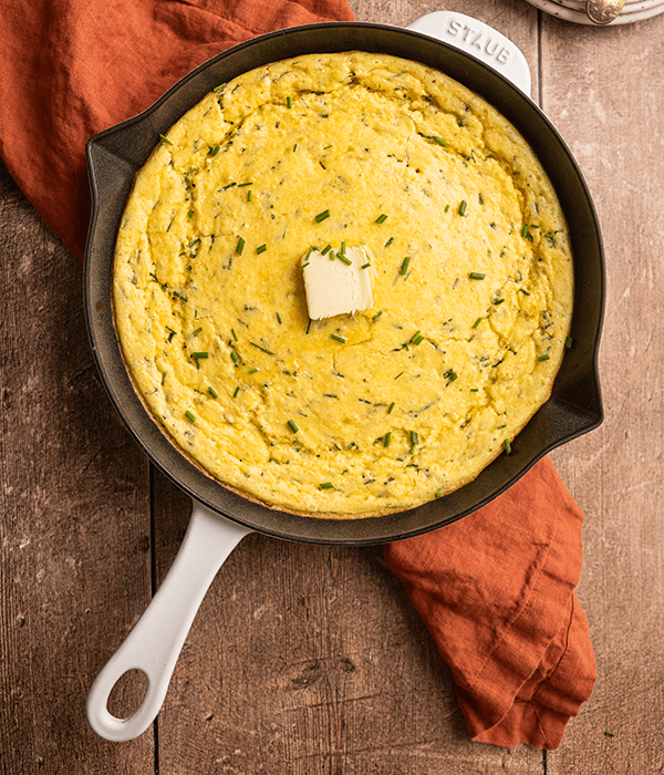 Cheddar Chive Spoon Bread in a Cast Iron Skillet