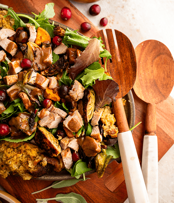 Green Salad with Turkey, Stuffing and Vegetables with Serving Spoons