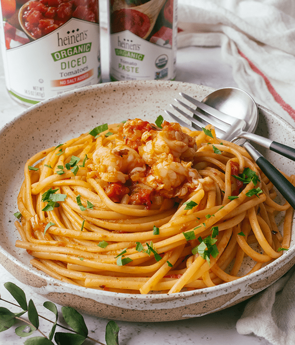 A Large Bowl of Lobster Fra Diavolo Pasta with a Fork and Spoon