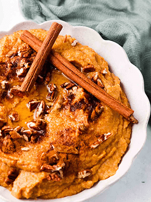 Cauliflower Sweet Potato Mash in a Bowl with Cinnamon Sticks and Nuts