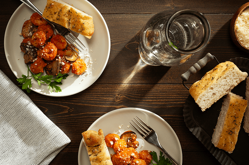 Gnocchi Alla Vodka with Mushrooms and a side of focaccia bread.